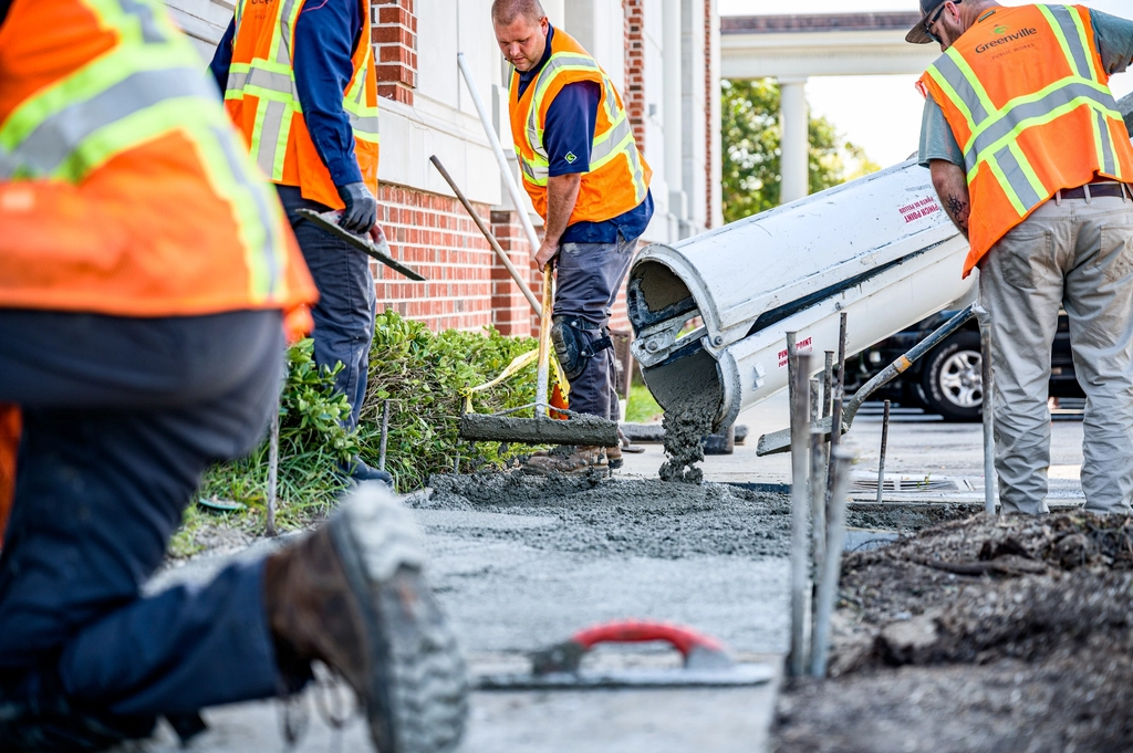 Concrete crew placing fresh concrete on a commercial job site