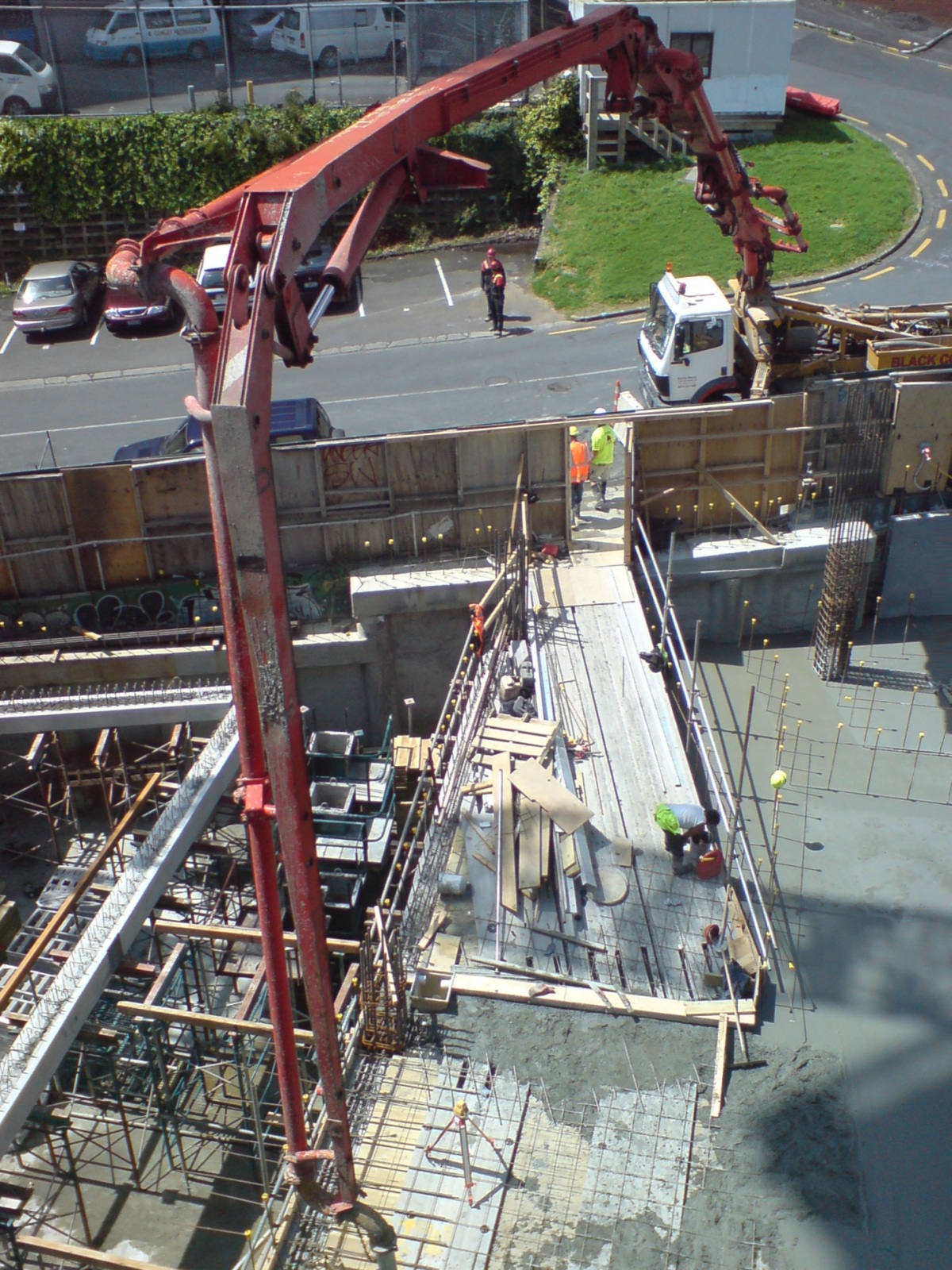 Concrete pump placing a slab at a commercial construction site